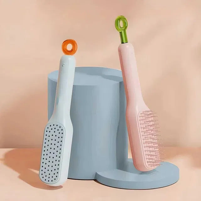 Two grooming brushes with different bristle designs and a brush holder on a peach background